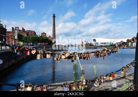 Liverpool, UK- Sept 7, 2022: Love locks hanging on a metal chain fence at the docks in Liverpool England Stock Photo