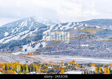 Aspen, Colorado USA small town aerial view with buttermilk ski slope in rocky mountains and small airport runway in roaring fork valley covered in win Stock Photo