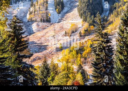 Aspen, Colorado buttermilk ski slope hill peak in rocky mountains on sunny day with snow on yellow foliage autumn or winter trees closeup Stock Photo