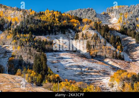 Aspen, Colorado buttermilk highlands ski slope hill peak in rocky mountains on sunny day with snow on yellow foliage autumn or winter trees closeup Stock Photo