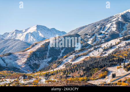 Aspen, Colorado buttermilk ski resort town slopes hill in Rocky mountains view on sunny day with winter snow on yellow foliage autumn trees Stock Photo