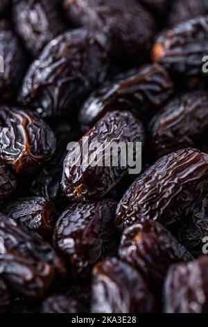 Full frame background top view of pile of appetizing dried date medjoul fruits arranged on surface Stock Photo
