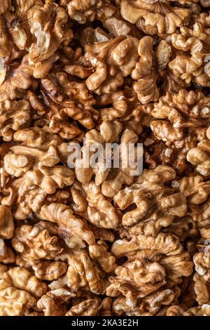 Full frame top view of heap of fresh raw brown crispy walnuts arranged on surface Stock Photo