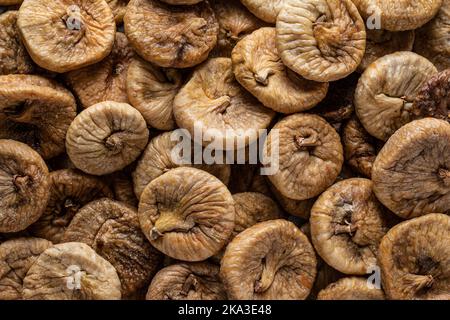Full frame high angle of shrunken dehydrated Turkish figs stacked in pile on counter Stock Photo