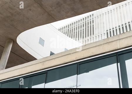 From below of concrete and glass elements of contemporary multistory building with column and panels Stock Photo