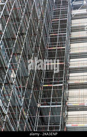 From below scaffolding around modern building during renovations Stock Photo