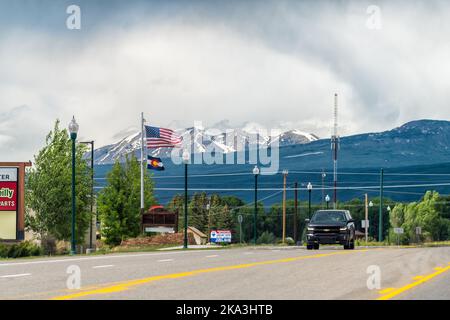 Gunnison, USA - June 20, 2019: Highway 50 road with traffic cars in small city, moountains town and mount Crested Butte of Rocky mountains in backgrou Stock Photo