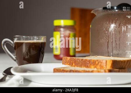 Breakfast served! Coffee, bread and jam. Coffee jug on the table. Stock Photo