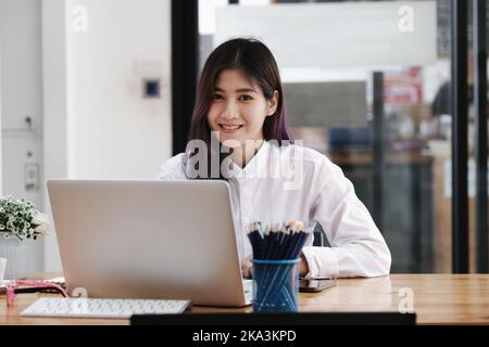 new normal, a businesswoman useing computer to work for a company Via the internet on your desk at home. Stock Photo