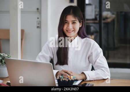 new normal, a businesswoman useing computer to work for a company Via the internet on your desk at home. Stock Photo