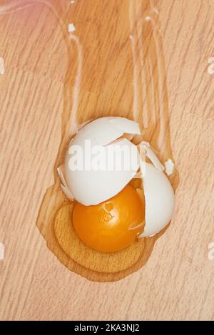 broken egg on the wooden floor. Stock Photo