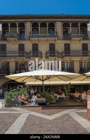 Young people bar, view in summer of a group of young people sitting on a cafe-bar terrace in the Piazza Duomo in the center of the city of Como, Italy Stock Photo