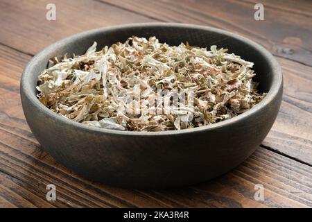 Bowl of dried Iceland moss for making healthy herbal cough tea.  Icelandic moss, natural cough medicine. Alternative herbal medicine. Stock Photo