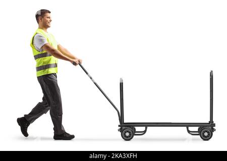 Airport worker pushing a luggage cart isolated on white background Stock Photo