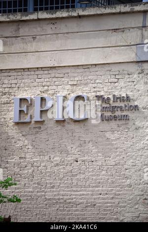 Vertical shot of the EPIC signboard. The name of the Irish Emigration Museum in Dublin city center. Logo mounted on bright painted old brick wall. Stock Photo