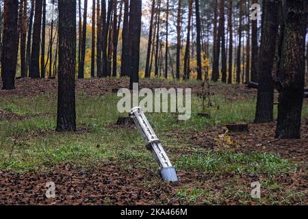 KHARKIV REGION, UKRAINE - OCTOBER 26, 2022 - The remains of a missile are stuck in the ground in a forest near Izium after the liberation of the area Stock Photo