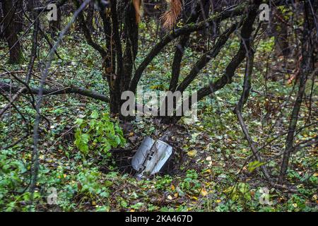 KHARKIV REGION, UKRAINE - OCTOBER 26, 2022 - The remains of a missile are stuck in the ground in a forest near Izium after the liberation of the area Stock Photo
