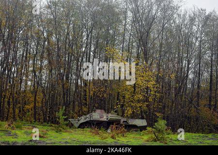 KHARKIV REGION, UKRAINE - OCTOBER 26, 2022 - A destroyed Russian military vehicle is pictured in a forest near Izium after the liberation of the area Stock Photo