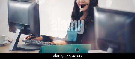 Corporate Contact us, It support, call center and customer service help desk concept, Young smiling woman with Headset on the computer mornitor with c Stock Photo
