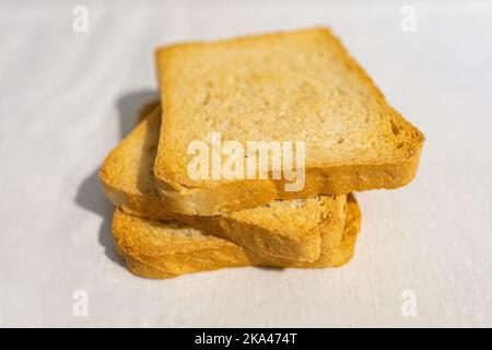 Selective focus on three rusks on a white background Stock Photo