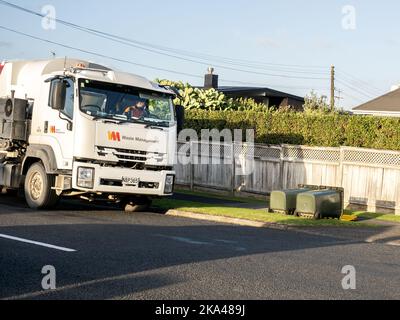 View of rubbish truck collecting wheelie bins toppled by strong wind Stock Photo