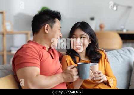 Closeup of happy loving asian couple drinking tea together Stock Photo