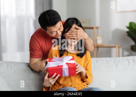 Loving man making surprise for St. Valentines Day or birthday Stock Photo