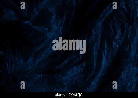 Dark plastic wrap background. Crumpled wrinkled plastic cellophane. Texture overlay effect template Stock Photo