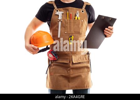 Carpenter in workers apron with hard hat and clipboard on white background Stock Photo