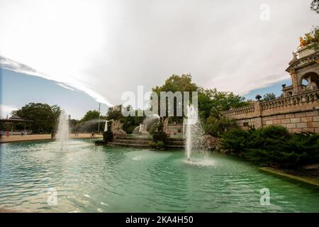 08-28-2022 Barselona, Spain. Ciutadella Park waterfall (Cascada del Parc de la Ciutadella) in Barselona and juniper trees Stock Photo