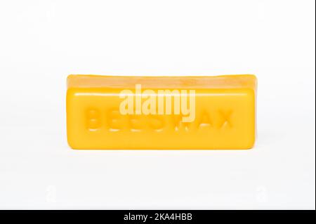 Single bar of yellow beeswax on white background Stock Photo