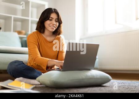 Online Education. Smiling Young Arab Woman Study With Laptop At Home Stock Photo