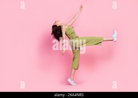 Full length profile side photo of positive satisfied lady go party event holiday weekend look empty space isolated on pink color background Stock Photo