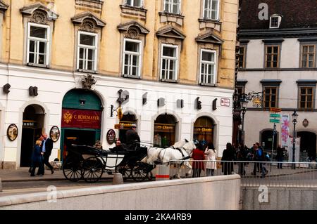 Viennese Fiakers two-horse drawn carriages are a part of the landscape of the capitol city in Austria. Stock Photo