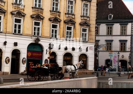 Viennese Fiakers two-horse drawn carriages are a part of the landscape of the capitol city in Austria. Stock Photo