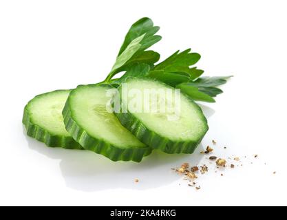 fresh raw sliced cucumber with parsley and pepper isolated on white background Stock Photo