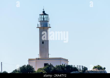 A white painted lighthouse on a sunny day with blue sky. Stock Photo