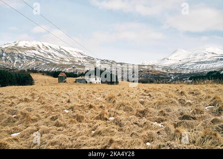 Houses in mountainous countryside with dry grass Stock Photo