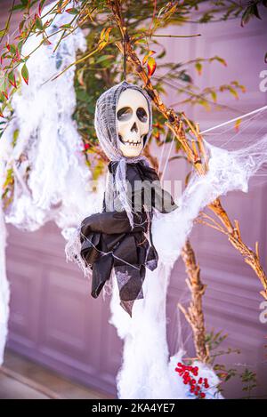 A ghoul with a skull mask Halloween decoration. Stock Photo