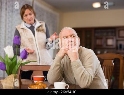 Senior couple after quarrel in living room Stock Photo