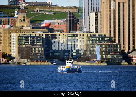 Halifax Transit ferry 'Vincent Coleman' sails past the Queen's Marque development on the Halifax waterfront in October 2022 Stock Photo