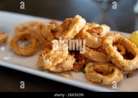 Italian style fried calamari on white plate Stock Photo