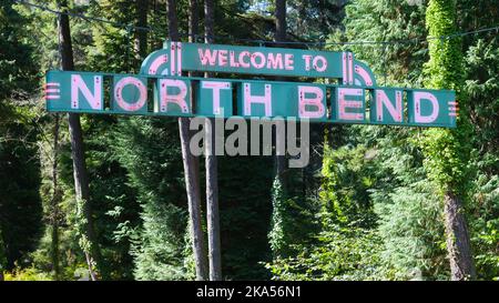 North Bend, OR, USA - September 16, 2022; Welcome to North Bend Oregon sign illuminated with red neon on green background in daytime Stock Photo