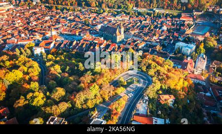Brasov, Romania - Aerial drone view of historical downtown, Council Square, Wthite Tower and Black Church, autumn landscape in Transylvania. Stock Photo