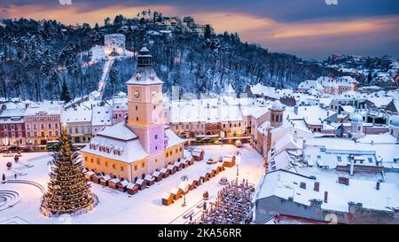 Brasov, Romania. Christmas time landscape with snowy city in Transylvania, Xmas Tree on Christmas Market. Stock Photo