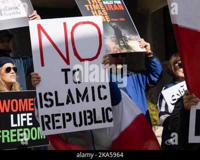 A protester carrying a sign that says, 'No to Islamic Republic' during a demonstration march decrying the Iranian government and the death of Masha Amini. Starting at the University of Nevada, hundreds of Reno's more than 2,000 Iranian Americans marched through downtown Reno calling for the end of what they said was Iranís oppressive, religious regime.Masha Amini was a central figure in the demonstrations. Amini was abducted by Iran's morality police and allegedly was murdered while in the custody of the Iranian government. (Photo by Bob Conrad/SOPA Images/Sipa USA) Stock Photo