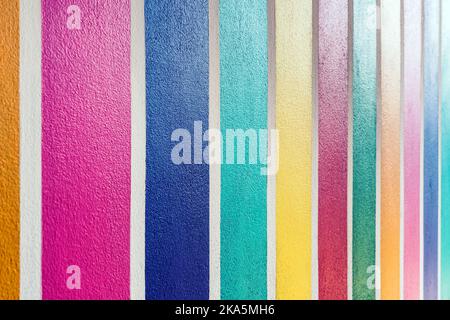 Multicolor vertical striped pattern on cement wall. Colorful painted on cement surface of the wall. Graffiti in the colors of rainbow. Colour full of Stock Photo