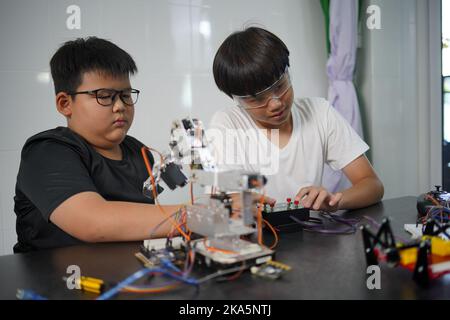An Asian boy works in a technology experiment at school. technology concept Stock Photo