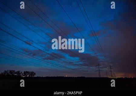 Landesbergen, Germany. 01st Nov, 2022. Electricity pylons stand on a road before sunrise. Chancellor Scholz has announced forthcoming key points to ease the burden on citizens and companies in the energy crisis. Credit: Lino Mirgeler/dpa/Alamy Live News Stock Photo