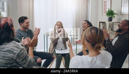 Group, clapping hands and counselling meeting for mental health, laugh and team happy, support and together in circle. Therapy session, depression and Stock Photo